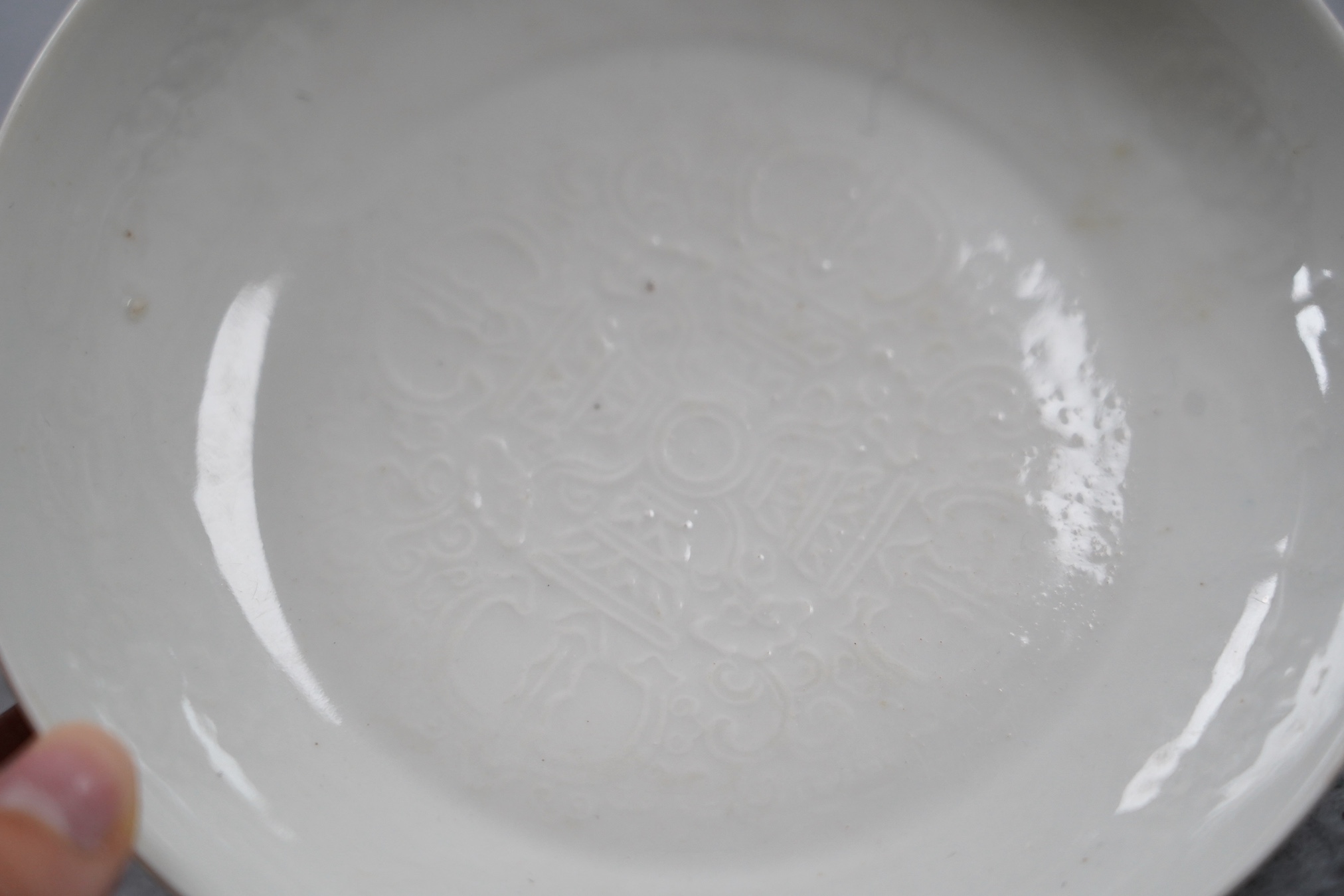 A Chinese moulded white glazed saucer dish, Yongle mark, Republic period